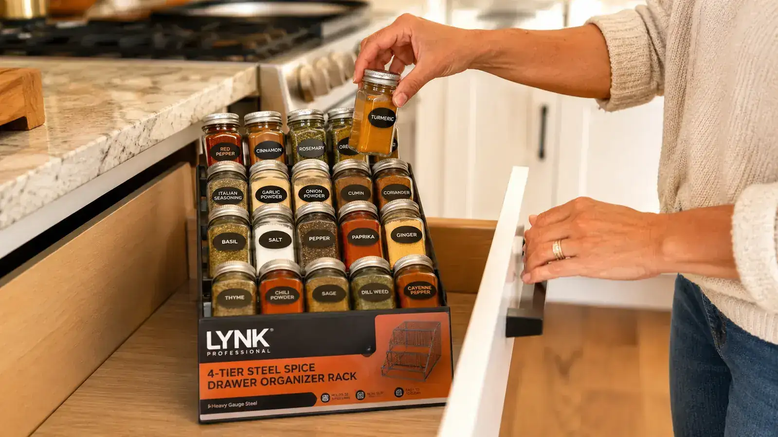 LYNK PROFESSIONAL 4-tier steel spice drawer organizer installed in a kitchen drawer with jars arranged by tier